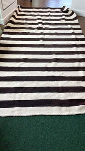 Black and white striped handmade tapestry rug with sheep wool, crafted by Qomle'ec women from Formosa, Argentina. Sized at around 9 by 9 feet. Embrace Qomle'ec culture and bring warmth and tradition to your space.
