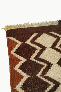 Close up of Dark Brown Special Size Wool Tapestry with Cream and Ochre Design details with Fringe ends.