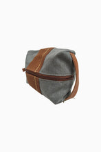 Load image into Gallery viewer, Side view of Light Gray Chaguar Travel Bag with Brown Stitching Designs. Dark Brown Zipper with Dark Brown Leather Handle on side.
