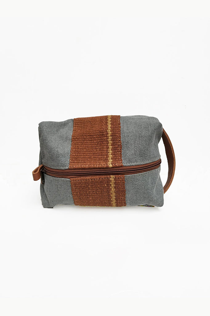 Light Gray Chaguar Travel Bag with Brown Stitching Designs. Dark Brown Zipper with Dark Brown Leather Handle on side.